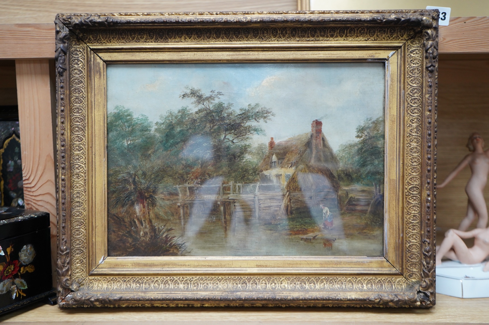 19th century, English School, Landscape with thatched cottage and stream, oil on canvas, gilt framed, together with a watercolour, Street scene, inscribed ‘Pinhorn Wood’, largest 24 x 34cm